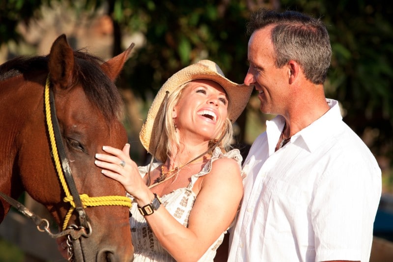 couple laughing with a horse in Roatan Honduras
