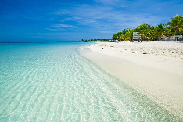 Tranquil Caribbean Sea lapping white sand in Roatan