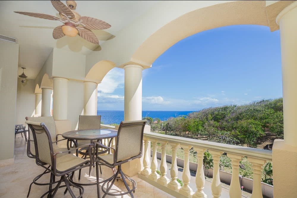 Snowbird rentals in Roatan include condos with sea views like this one with a spacious covered balcony and outdoor dining table